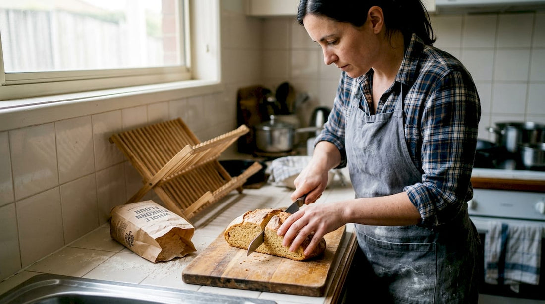 Slicing whole einkorn bread in rustic kitchen