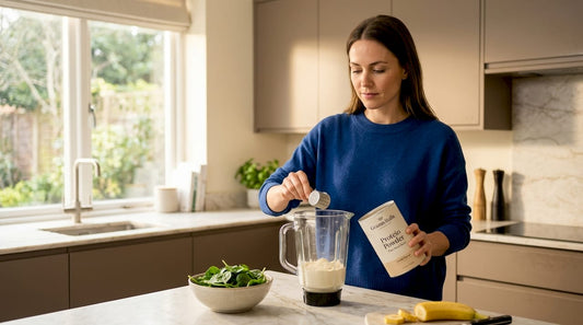 Woman measuring plant-based protein powder in kitchen