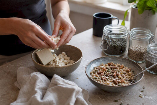 Hands preparing dairy-free protein breakfast bowl