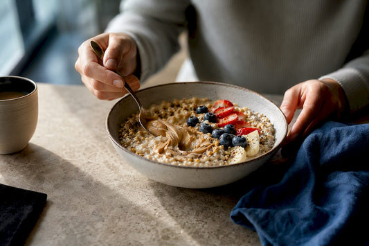 Layered high-protein oat bowl with berries and seeds