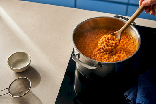 Split red lentils simmering in saucepan