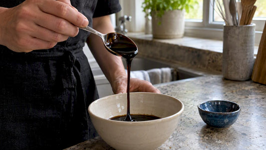 Blackstrap molasses measured over ceramic bowl