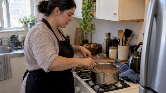 Cook whisking teff porridge on the stove